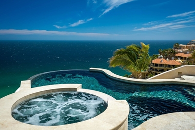 Take a dip into the villa's luxurious and uniquely shaped pool or lounge in the hot tub