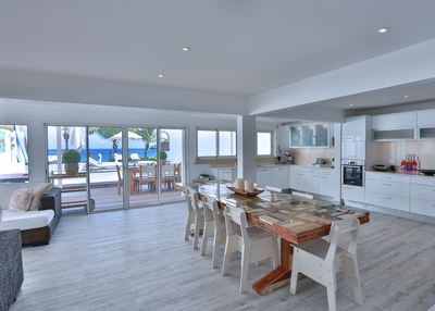 Kitchen & Dining Areas: Large dining table on the covered terrace by the kitchen and swimming pool, 
