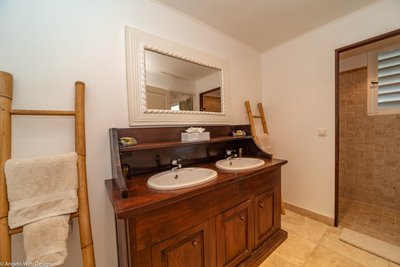 Petit Saint Louis | Bedroom 5 en-suite bath with shower, double vanity and hair dryer.